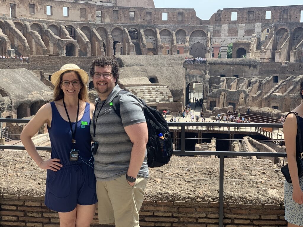a couple posing inside the ancient roman coliseum