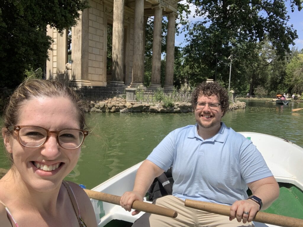 a couple rowing a boat inside a pond at Villa Borghese in Rome