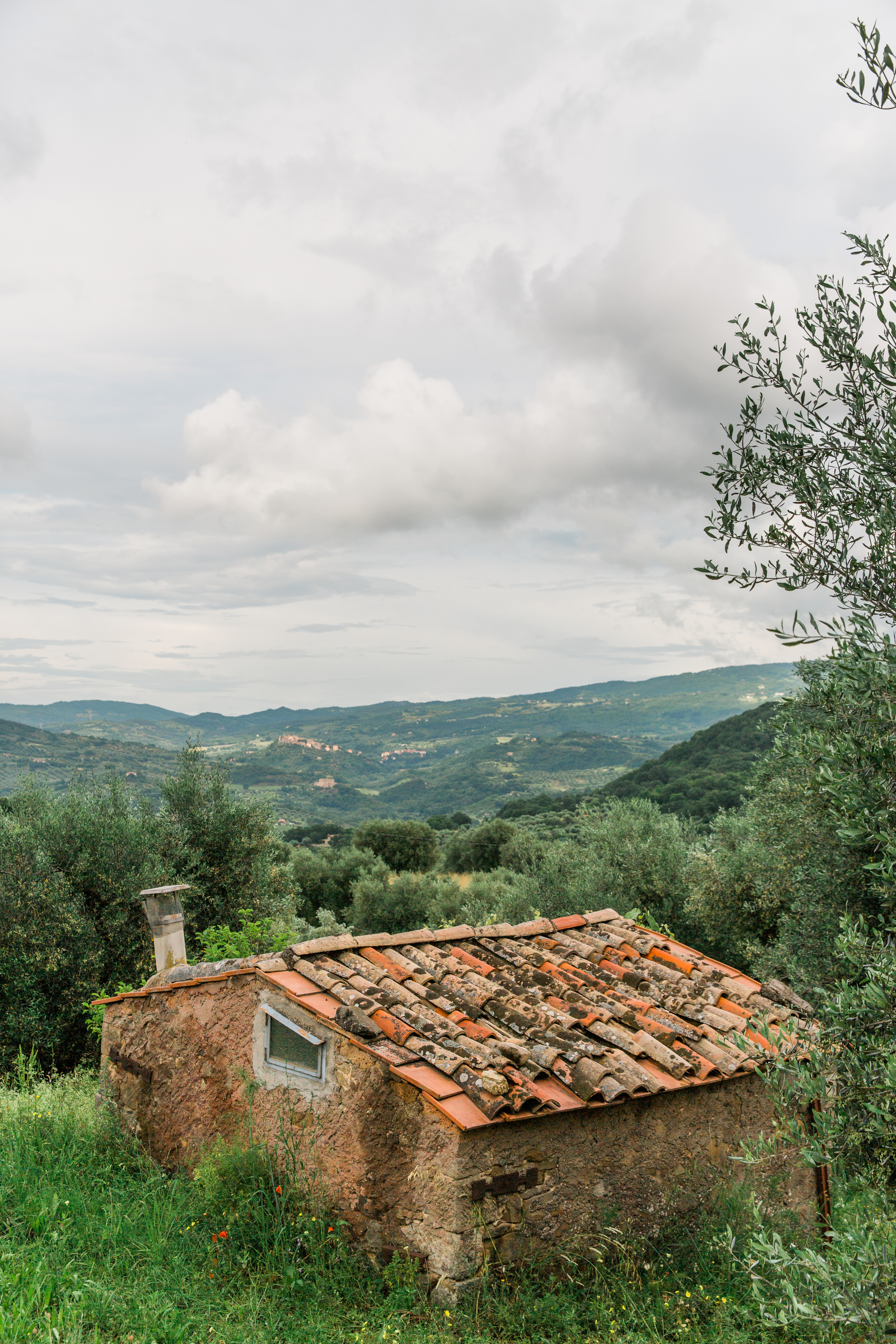 a tuscan country-side with a house