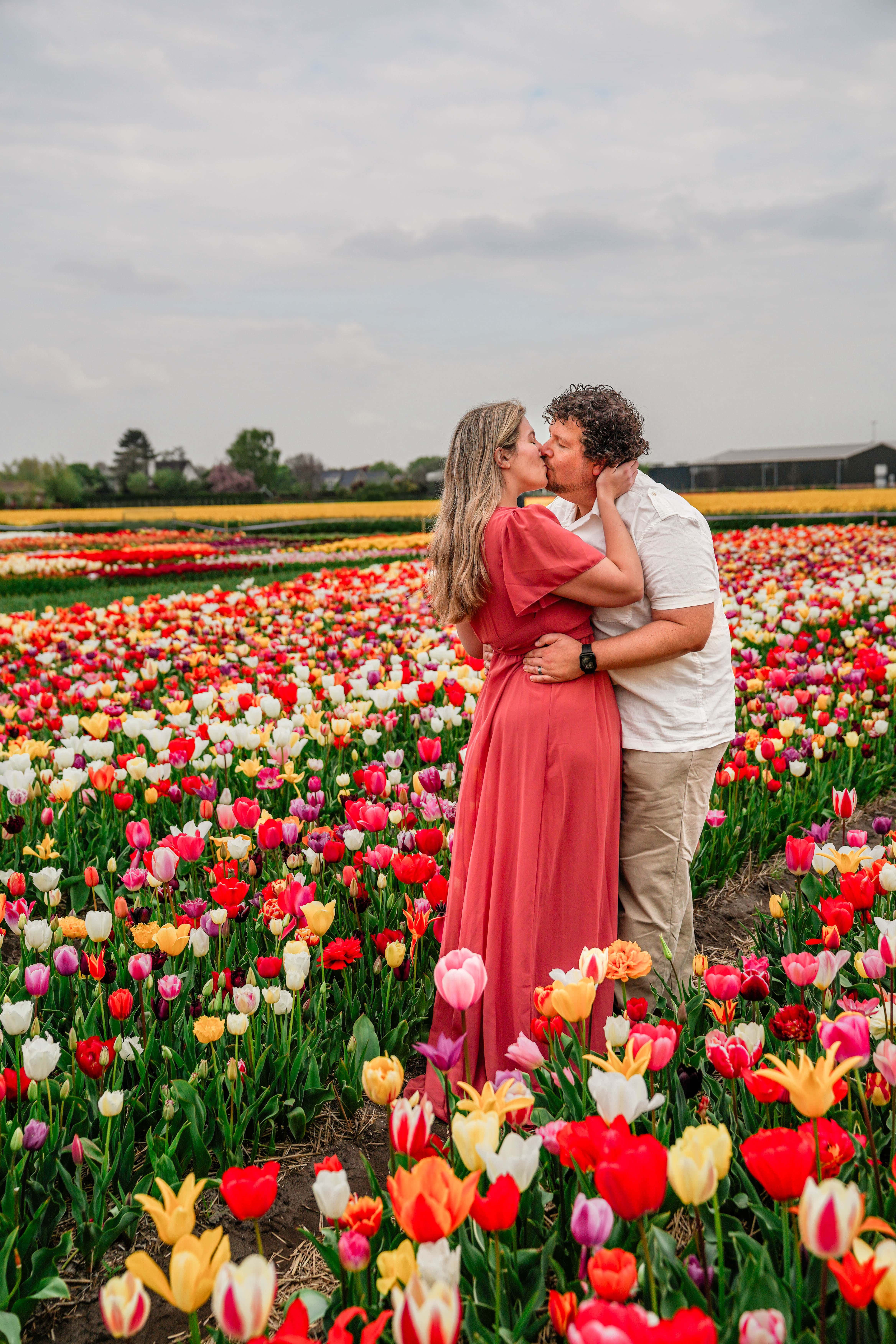 a couple kissing in tulips