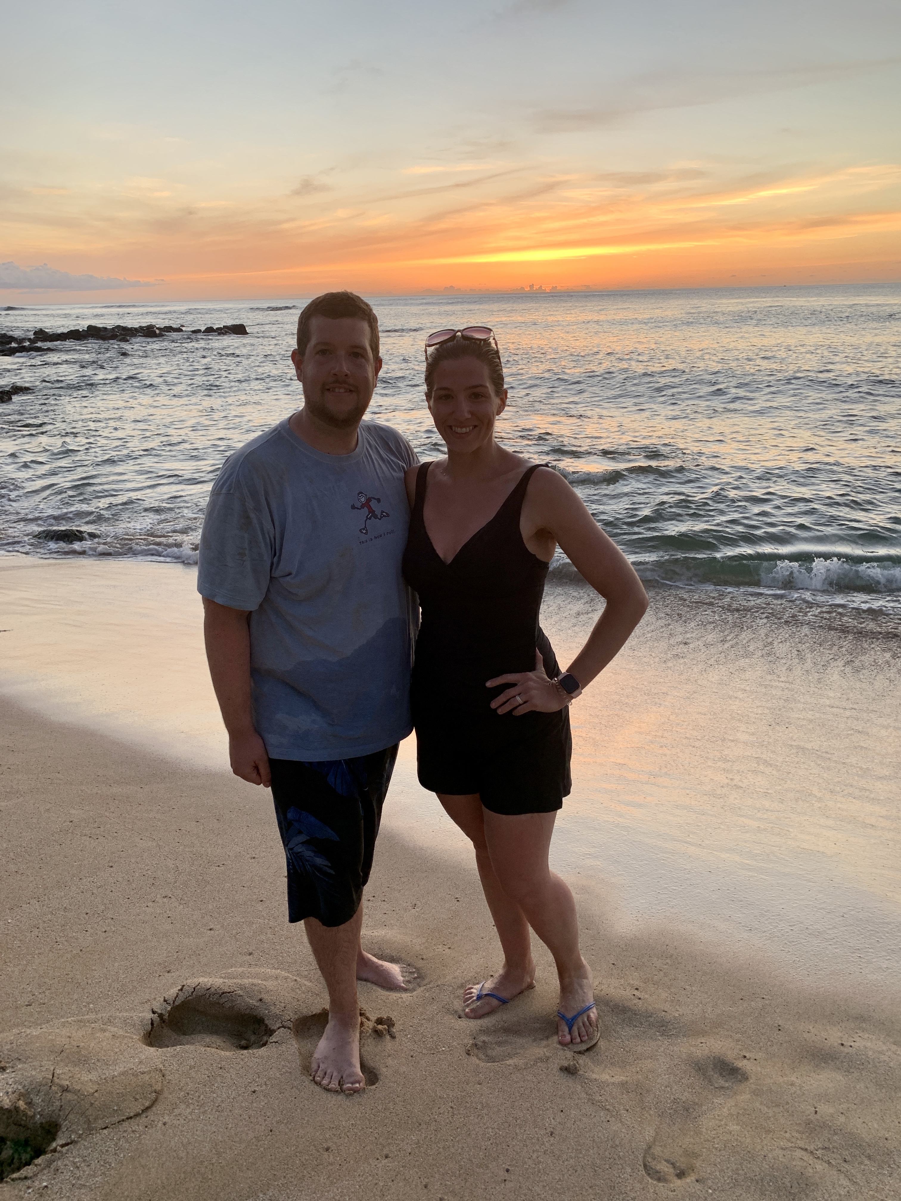 a couple on the beach during sunset