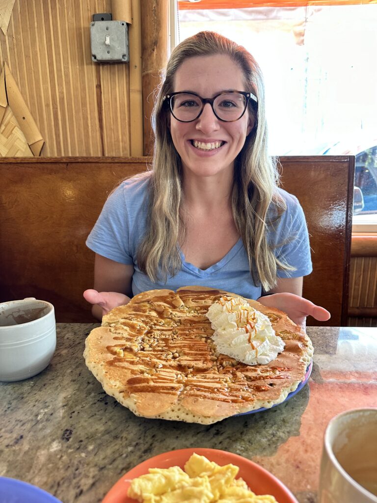 a girl with a giant pancakes