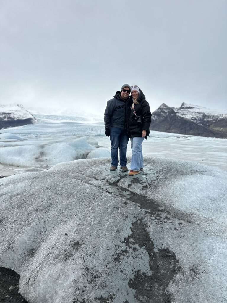 a couple standing on a glacier