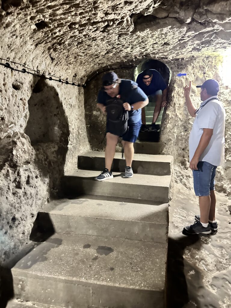a man crouching in a cave