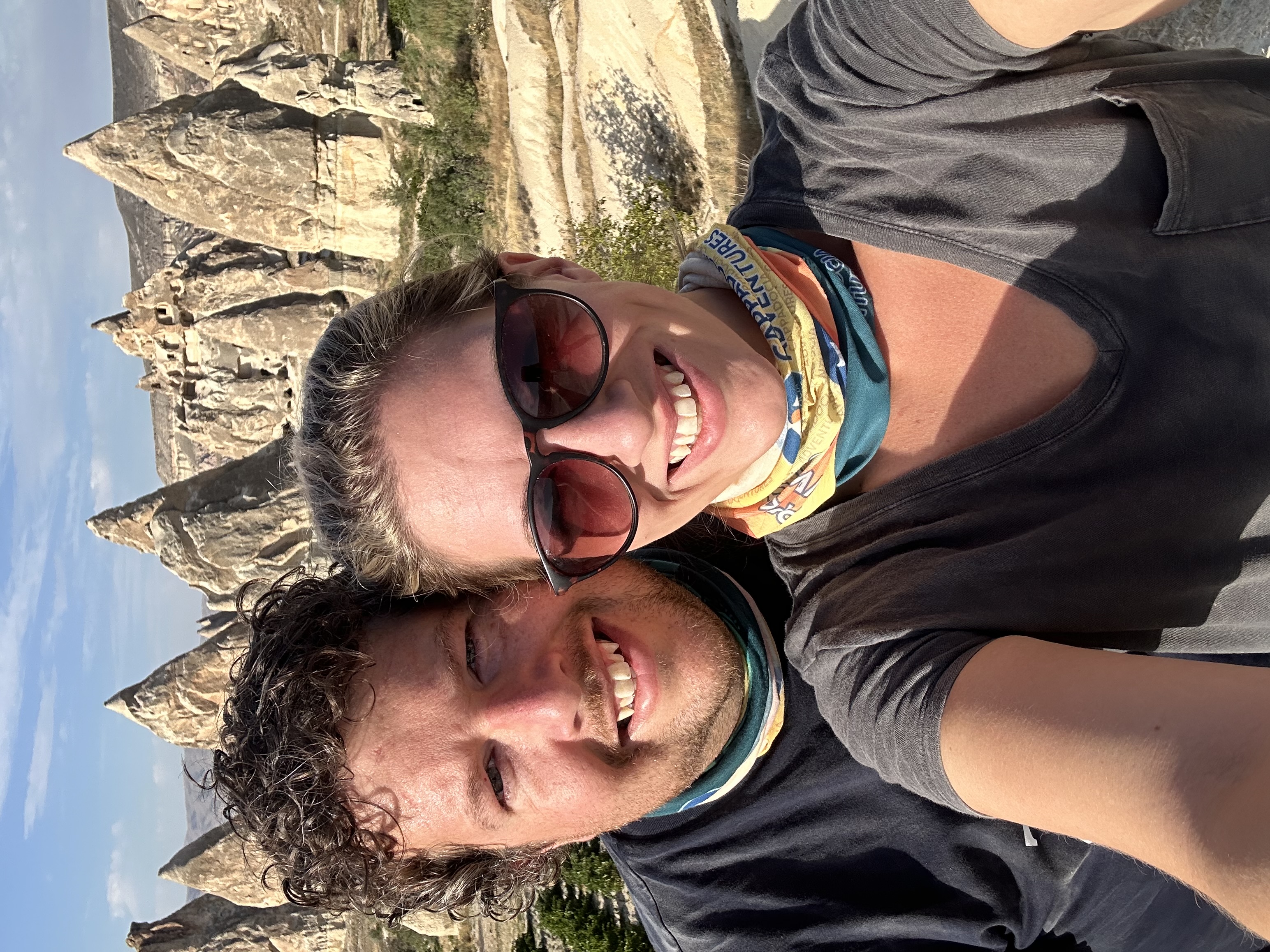 a couple posing with rock formations behind them