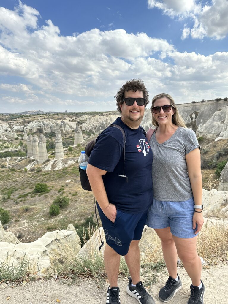 a couple posing with phallus rock formations