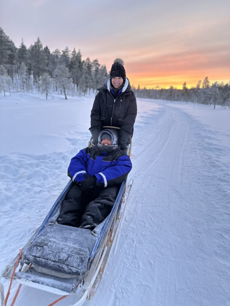 a couple in a dog sled