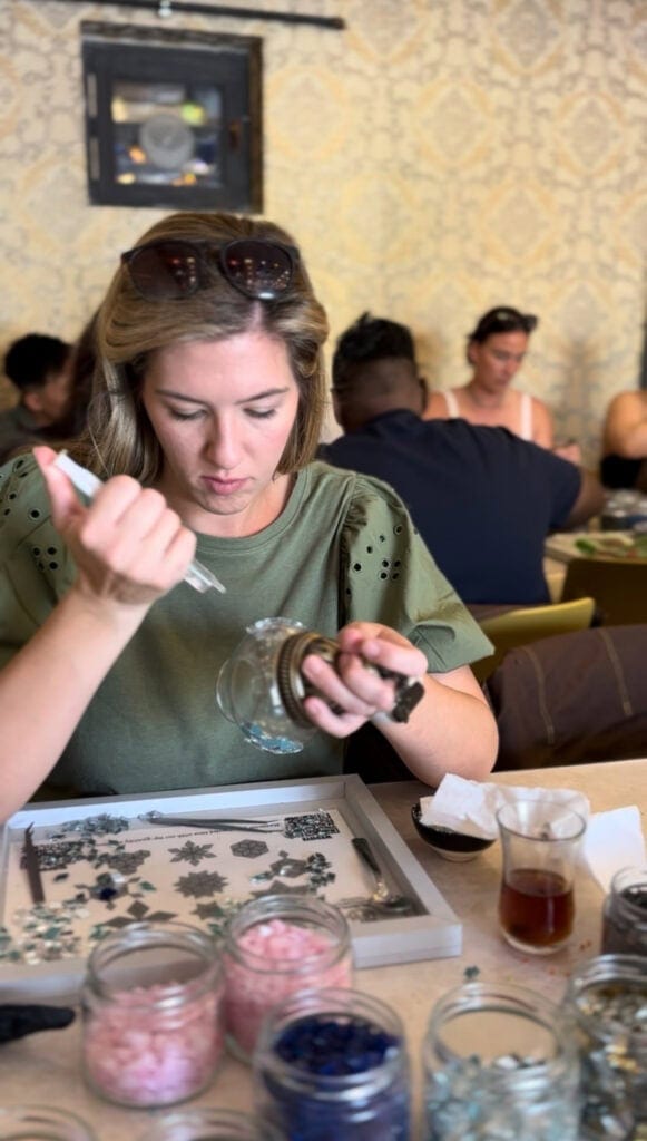 woman putting glue on lantern