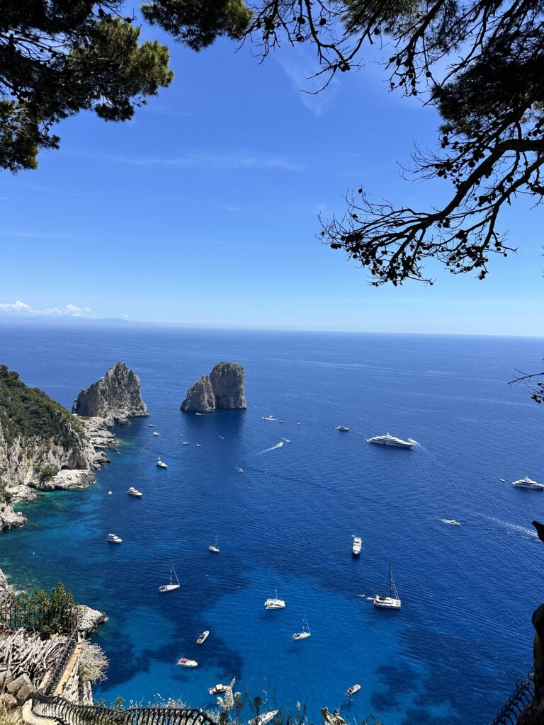 a view of jagged rocks sticking out of the sea