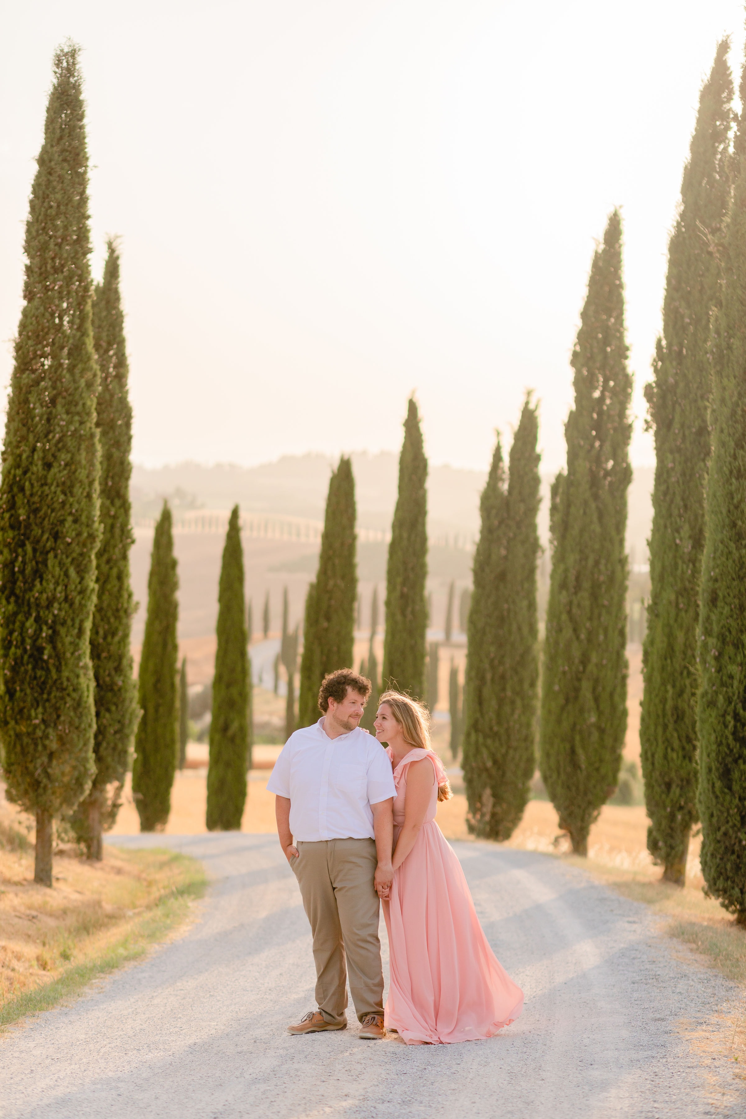 a couple surrounded by Cyprus trees