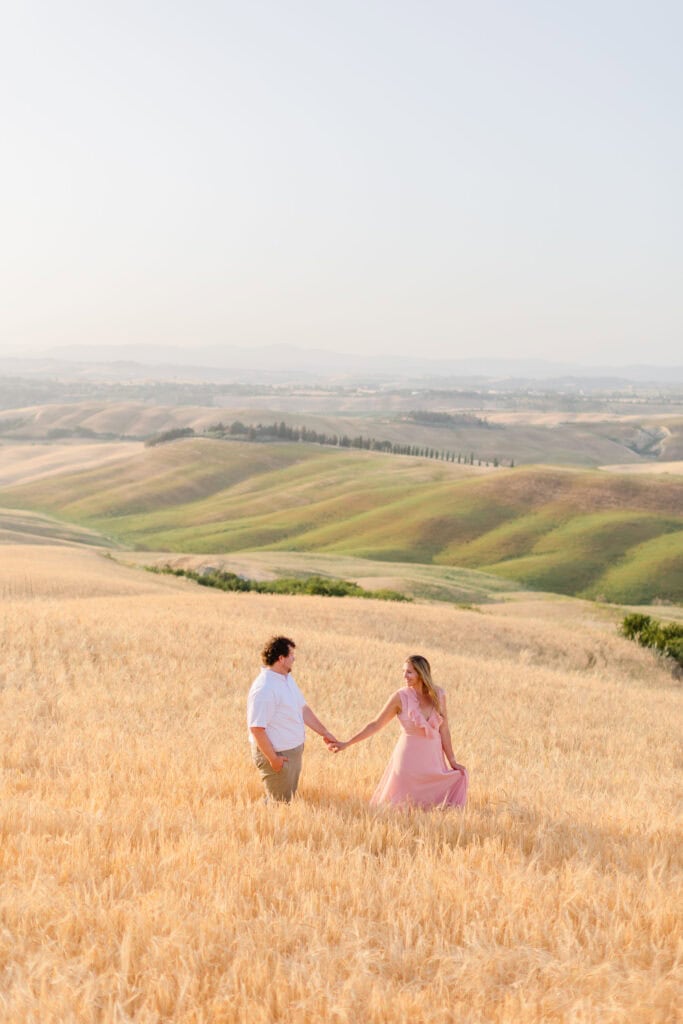 a couple surrounded by tall grass