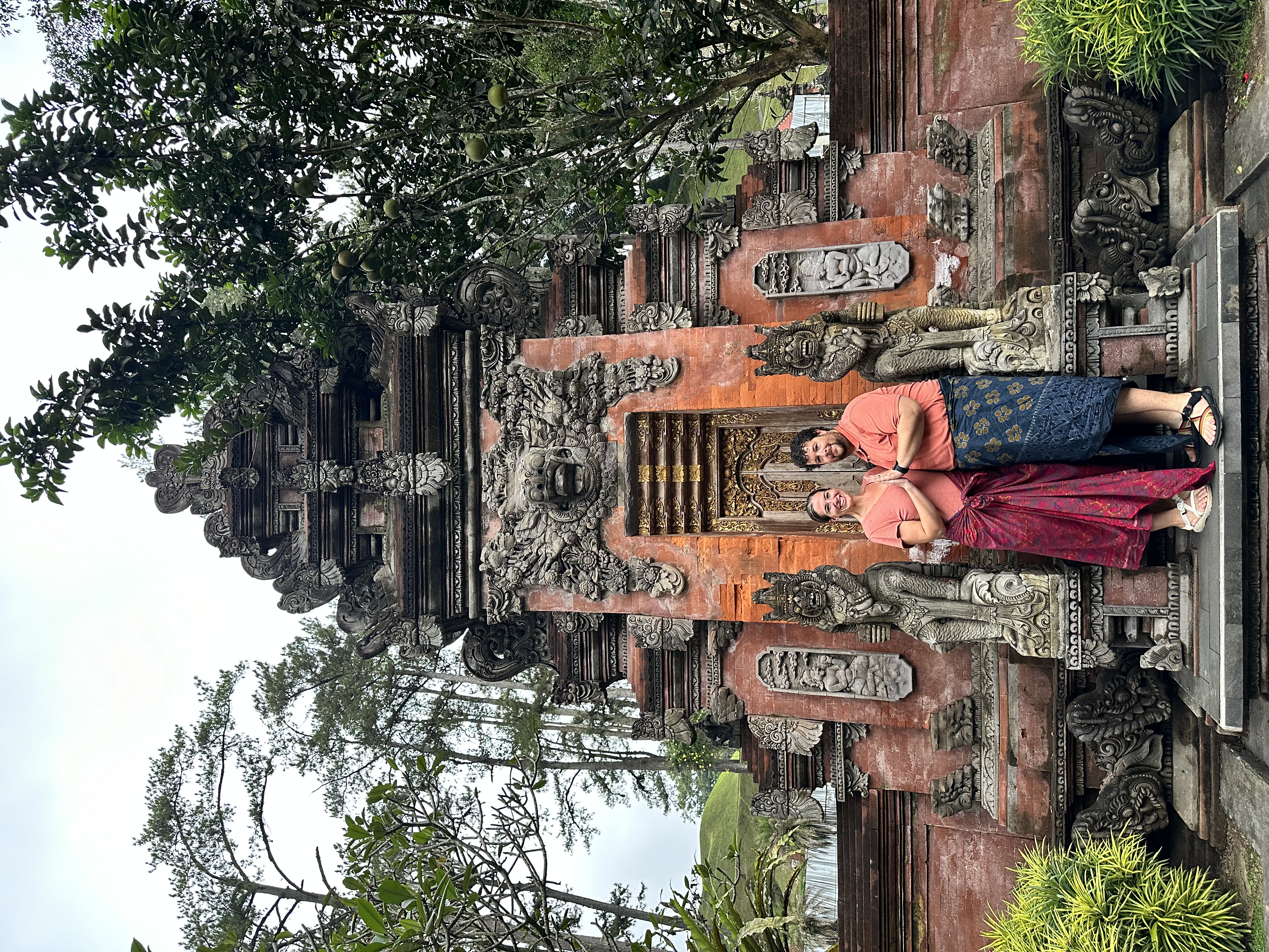 a couple holding hands outside a temple