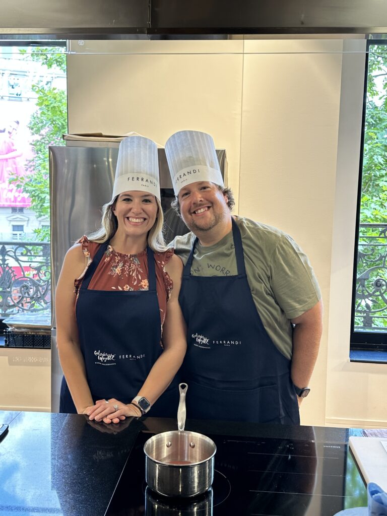 a couple wearing aprons and chefs hat