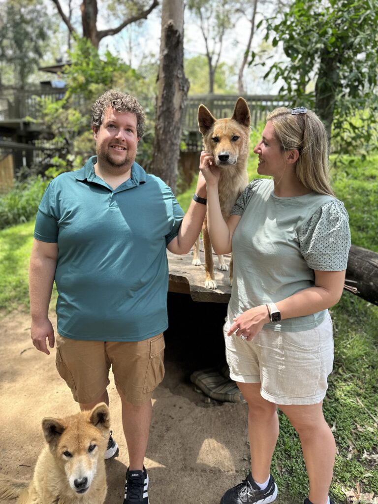a couple petting a dingo