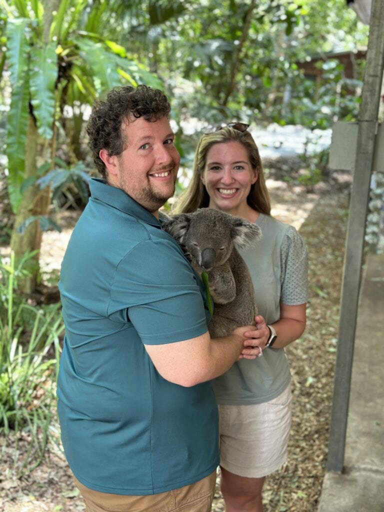 a couple holding a koala