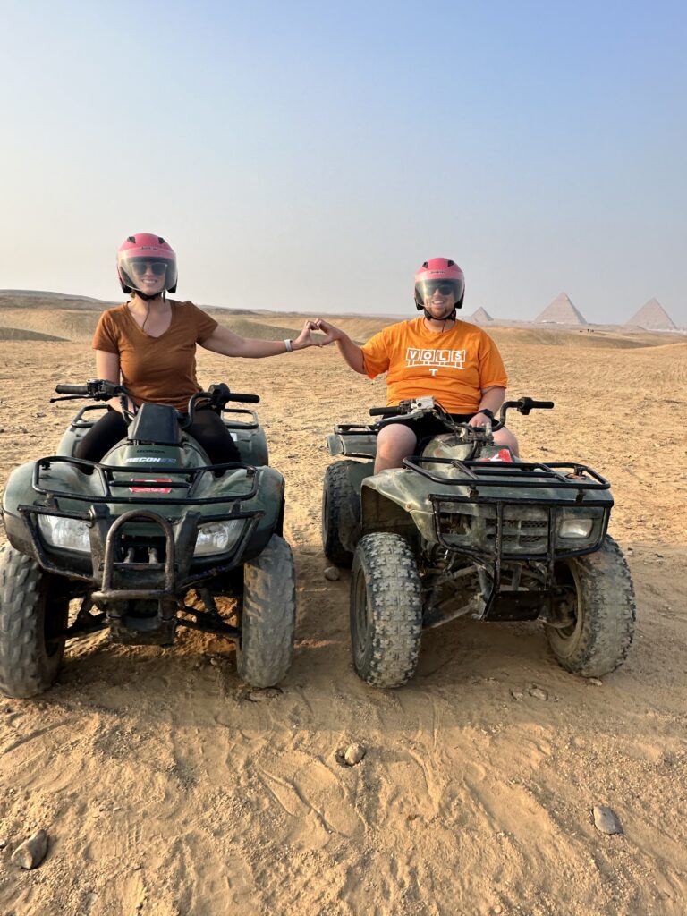 couple on ATV by Giza pyramids 